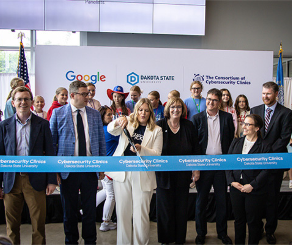 Dr. Ashley Podhradsky cuts the ribbon at the grand opening of the DSU Cybersecurity Clinic funded through Google.org.